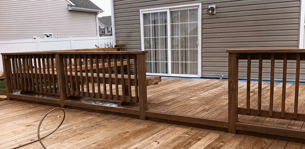 Deck sealing service protecting a backyard wood deck and railings in Tampa, FL