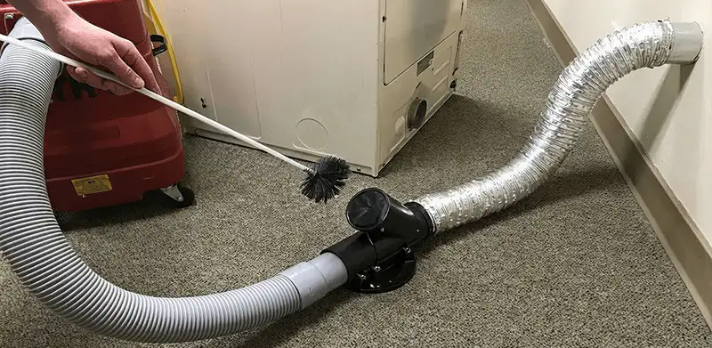 Dryer vent cleaning service removing lint from a dryer duct connection in Tampa, FL