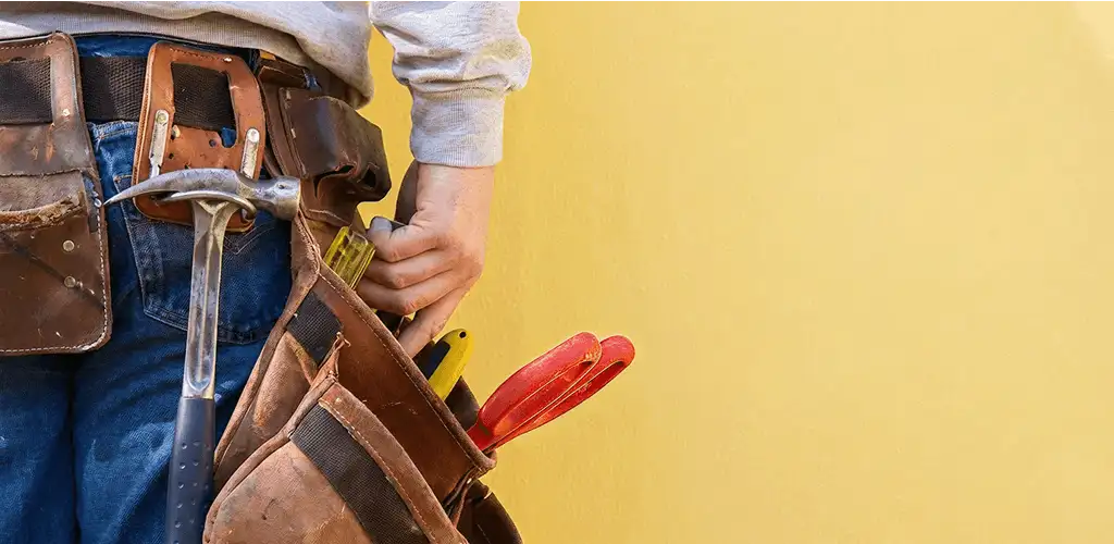 Handyman with tool belt ready for home repairs and maintenance in Tampa, FL