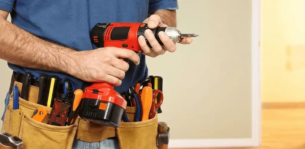 Handyman holding a power drill for home repairs and installations in Tampa, FL