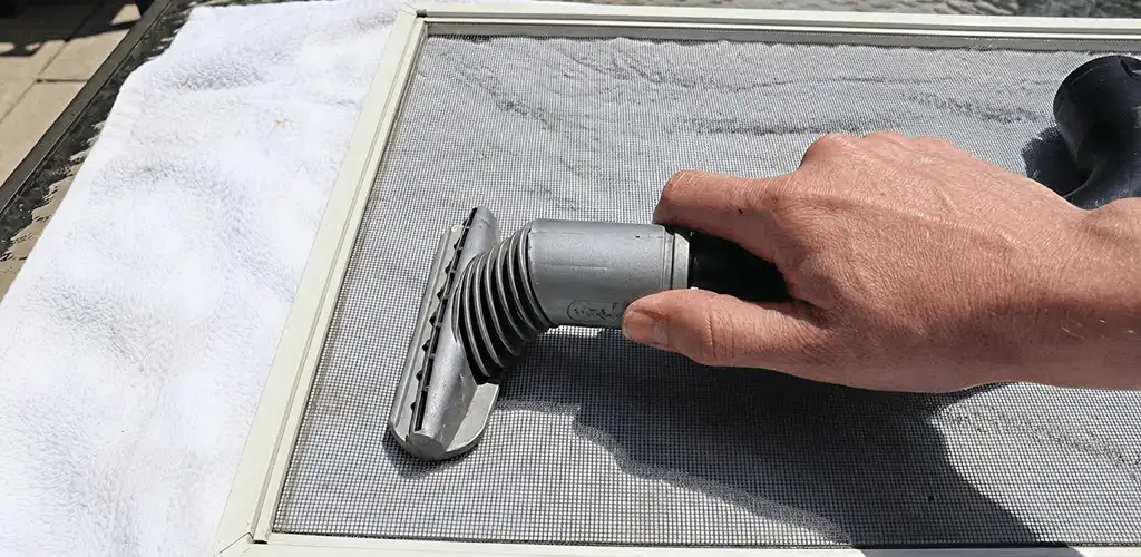 Window screen repair cleaning and fixing a damaged screen mesh in Tampa, FL